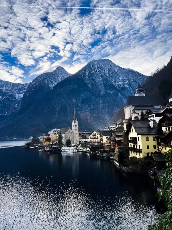 Iconic view of Hallstatt, Austria with a blue sky and clouds overhead
