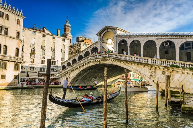 Rialto Bridge over the Grand Canal in Venice, with a Gondola floating underneath
