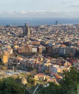 Barcelona city skyline featuring La Sagrada de Familia, the Mediterranean Sea, and city blocks as seen from the Carmel Bunkers
