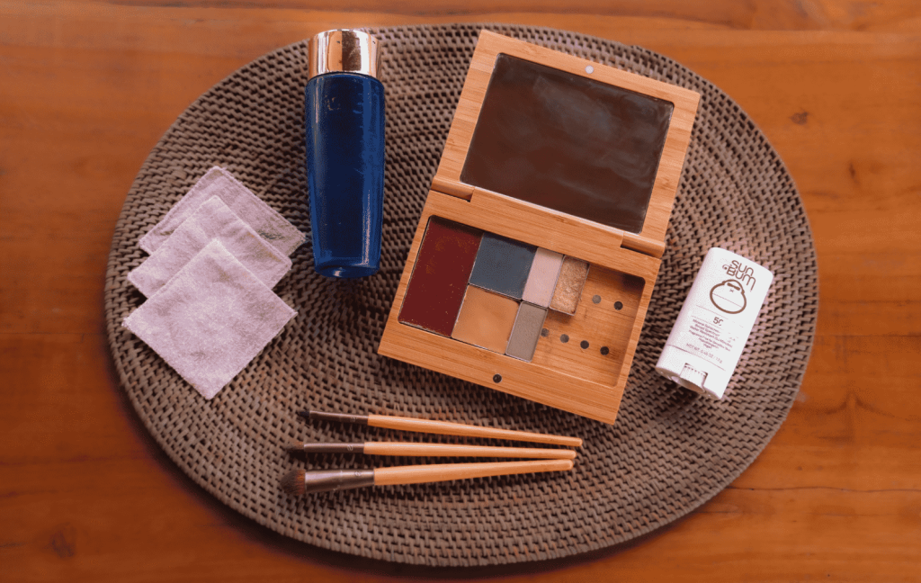 Open makeup palette, DIY makeup remover, reusable cotton rounds, and eco-brushes