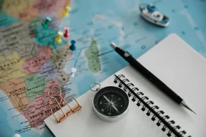 Map for travel planning with a notebook and pen