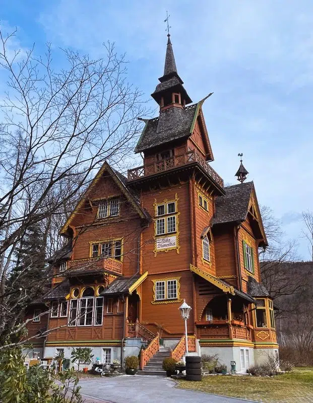 Intricate Austrian home, brown with yellow trim that looks like a gingerbread house