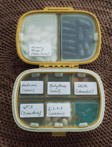 Open medicine organizer with various pills to use for travel